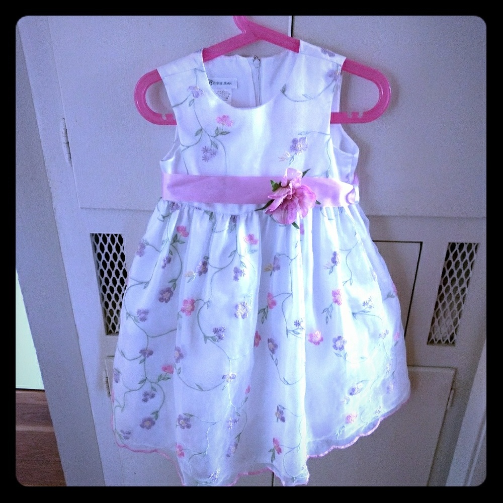 White dress with embroidered flowers.